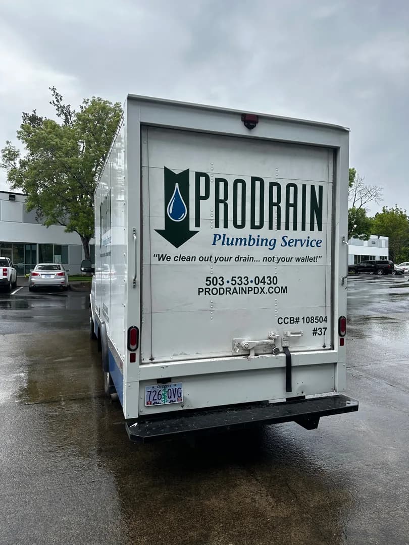 Full rear view of Pro Drain graphics on the GMC box truck