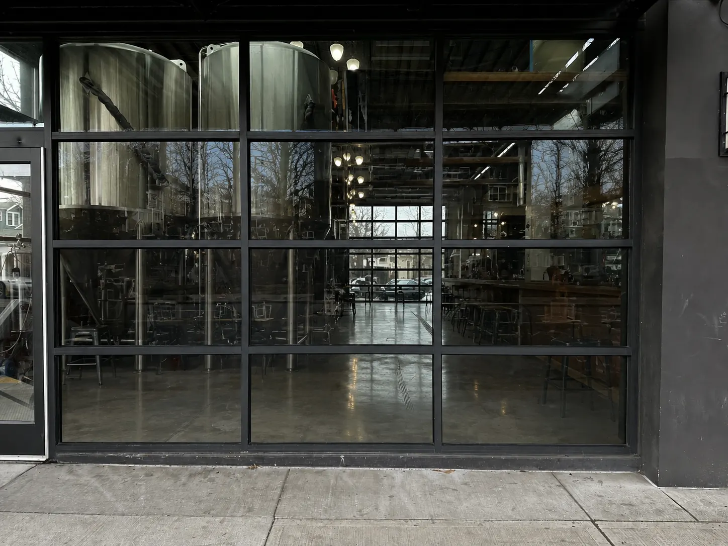 Bare storefront glass at Old Town Brewing before Baby Doll Pizza window graphics were installed