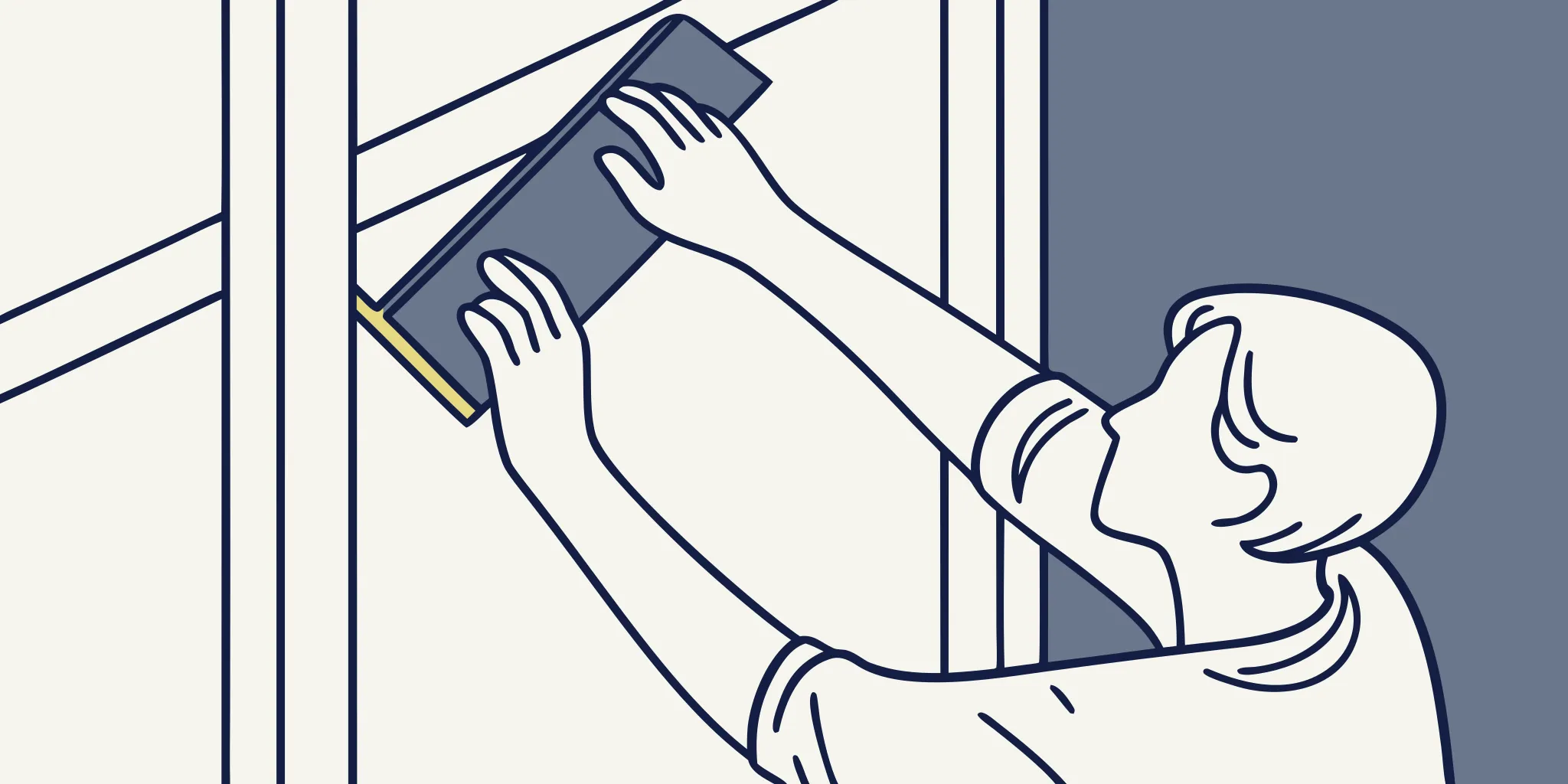 Professional installer smoothing a vinyl wall mural for office branding with a squeegee
